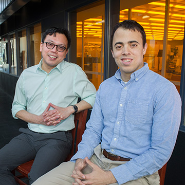 Dr. Wilbur Lam and his mentee Rob Mannino sitting in front of a laboratory to discuss Rob's research