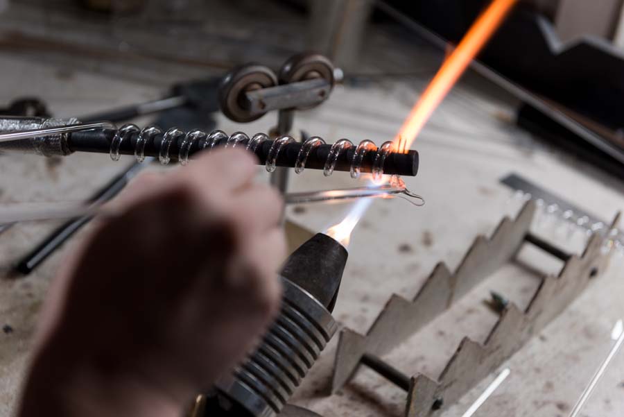 In instances in which the material to be heated is quartz, the temperature of the flame ranges from 2,500 degrees Fahrenheit to as high as 3,500 degrees.