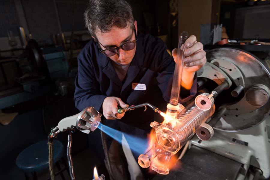 He is preparing the port to seal the new ball joint and flame annealing the finished repair.