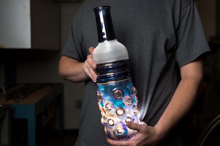 When not at work, Markowicz occasionally blows glass to make art such as this decorative bottle.