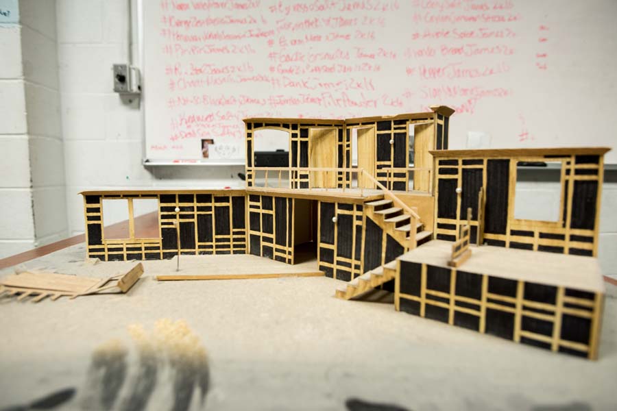 An architectural model of the set for 'Noises Off' sits on a shelf backstage.
