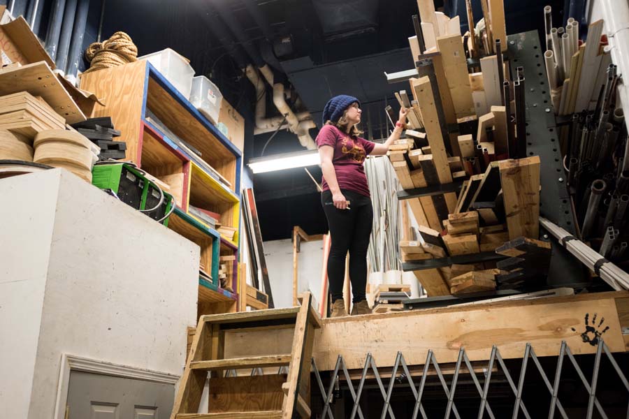Caleigh Derreberry, a second-year literature, media, and communication major and DramaTech’s marketing director, stands on the wood dock of the area where sets are built.
