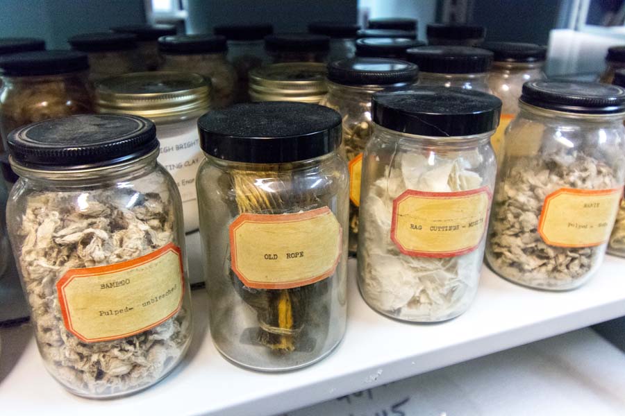 Samples of materials used to make paper, including bamboo, old rope, rag cuttings, and ramie are meticulously labelled.