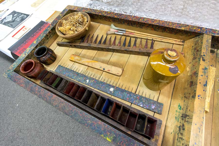 This tray, shown with rakes, combs, and paint containers, was used for marbling paper.