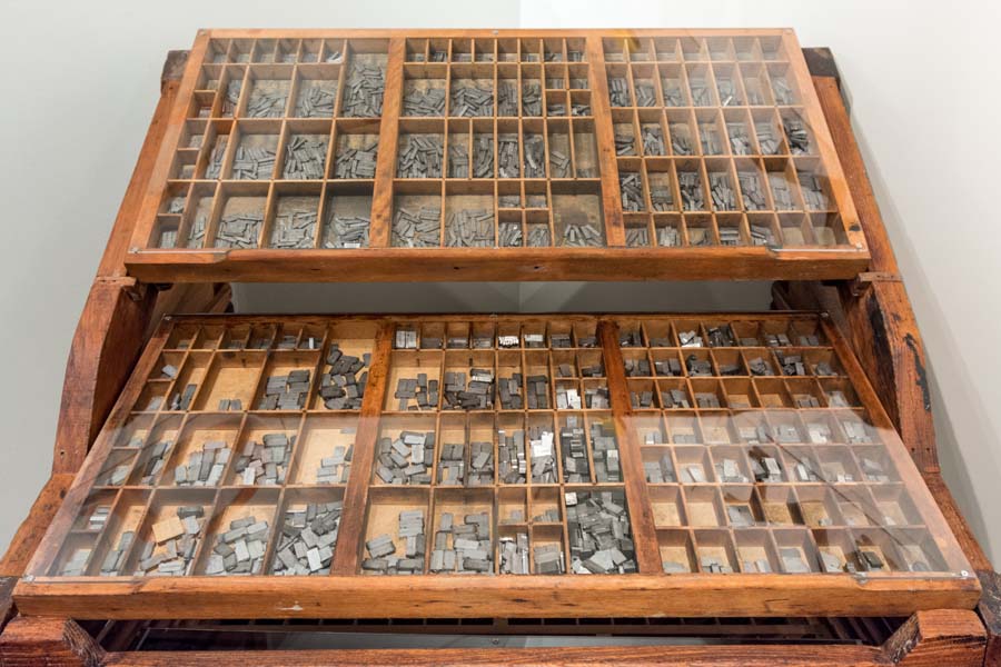 This two-tiered typecase holds letters used for type-setting. The top tier or “upper case” holds capital letters, and the bottom tier or “lower case” holds small letters.