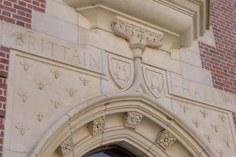 The entrance to Brittain Dining Hall displays the shields of the Army and Navy and a swarm of yellow jackets.