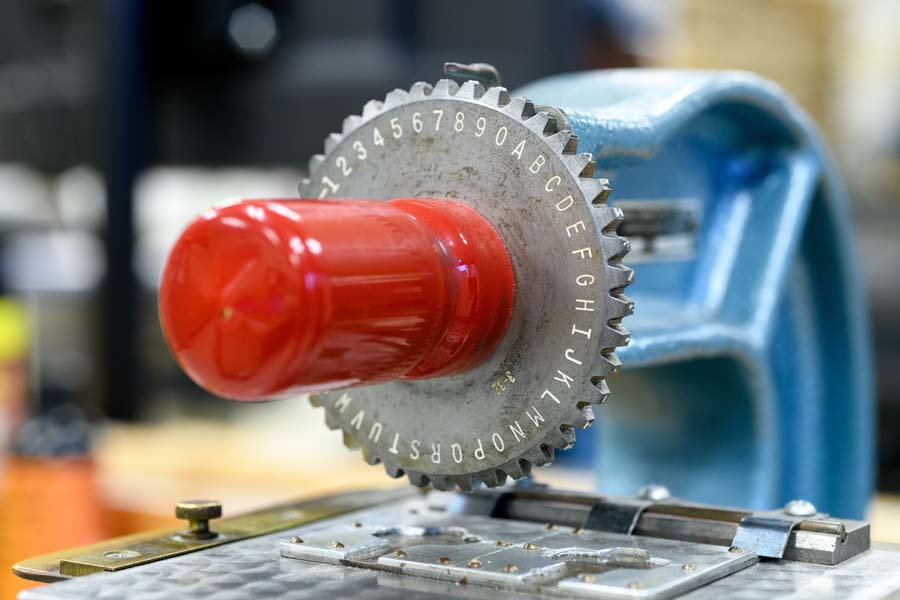 This machine stamps letters and sequential numbers on keys.