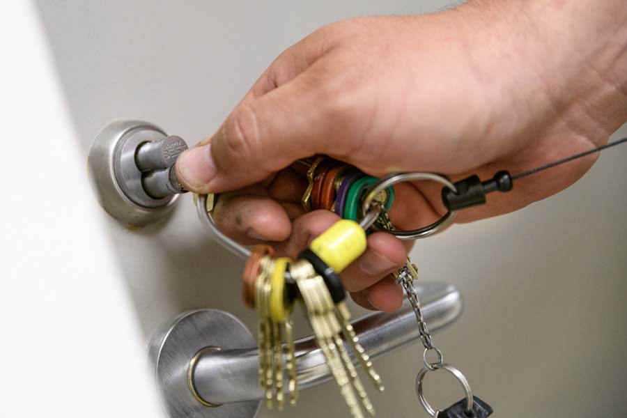 Pulling the lock core from a door to install a new lock.