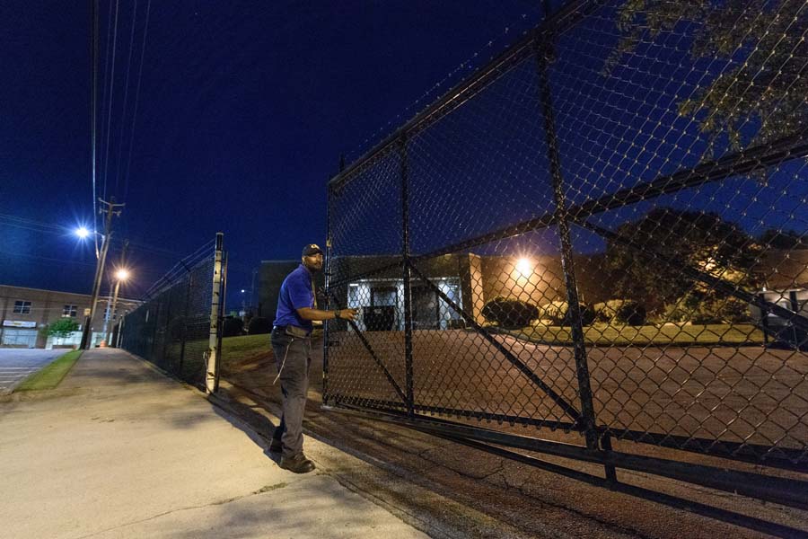 Rise and shine! Kenric White, courier II with the Georgia Tech Post Office, opens the gate at 5:30am for the mail truck.
