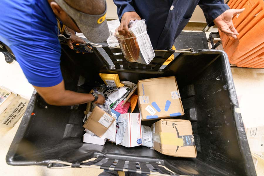 On its busiest days, the Postal Distribution Center processes six to eight 80-pound carts of mail.