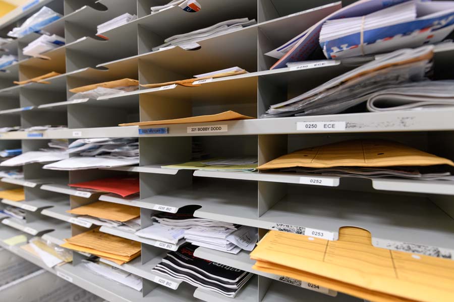 Incoming mail is sorted and bundled by campus mail code for delivery.