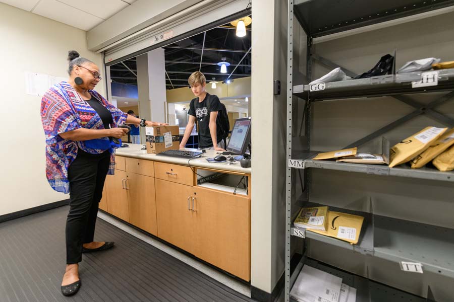 Aerospace engineering major Ben Hanscom, who started at Tech this summer, scans his BuzzCard and picks up a package.