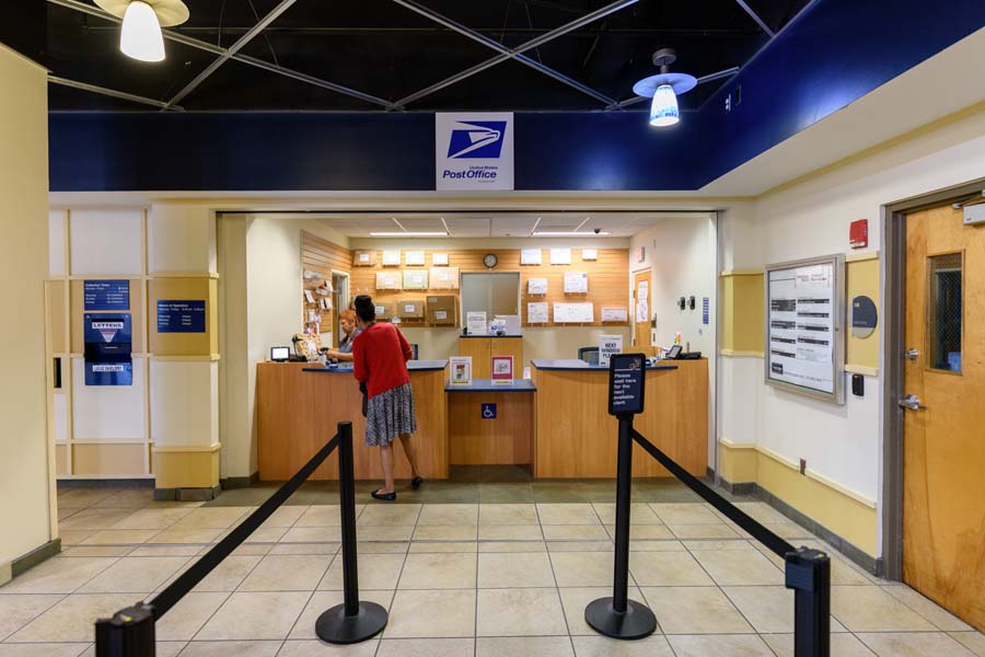Mail clerk Karen Jesnowski helps a customer at the Student Center Post Office.