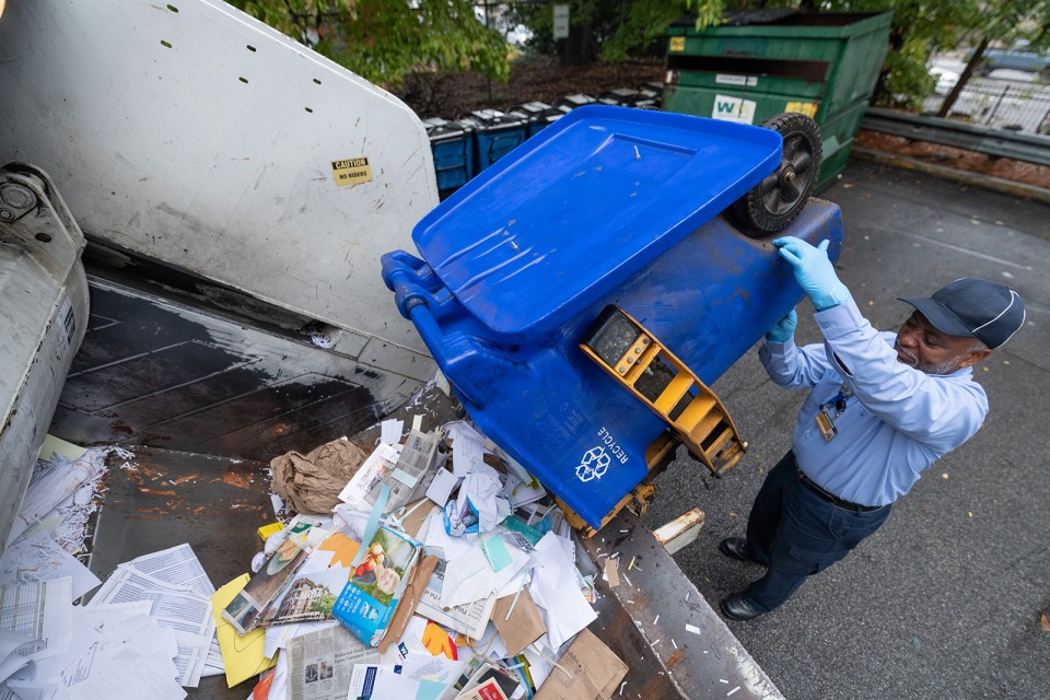 Johnny Rand, campus recycling specialist, empties a bin of paper into a compacting truck. Tech recycles more than 220 tons of paper each year, or more than 4 tons per week.