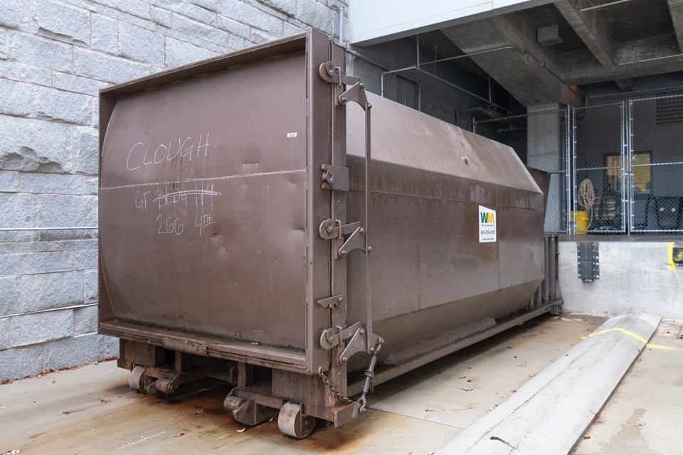 A trash compactor behind the Clough Undergraduate Learning Commons is used to collect interior trash, which is hauled by Waste Management.