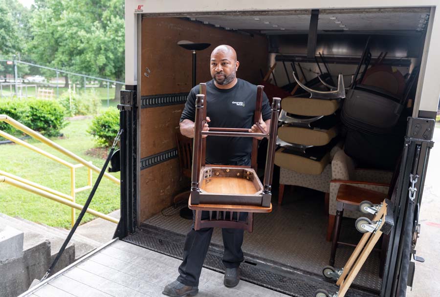 Georgia Tech Logistics is responsible for the campuswide pick-up of surplus items. Corey Darden, logistics associate, unloads furniture delivered to Surplus Property.