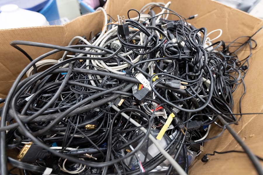 If no department wants an item, like this box of power cords and electronic accessories, the item is sent to the state-approved recycler after one to three months, depending on the item.