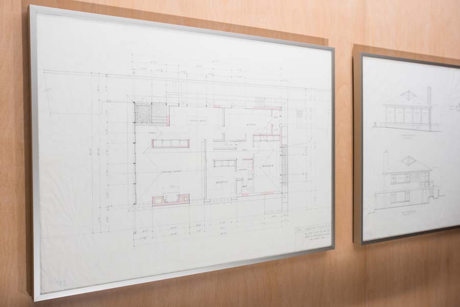 Floor plans of the house are featured on one wall of the living room.