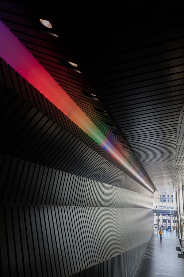 The main lobby and corridor of the Marcus Nanotechnology Building has a row of multi-colored lights along the ceiling.