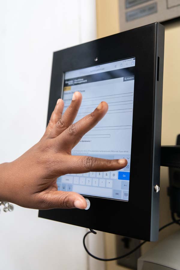 A sustainable work request kiosk allows customers to drop off and pick up vehicles without using paper.