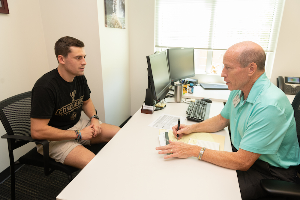 Stan Broome talks with student Max Rehberger about his career goals.
