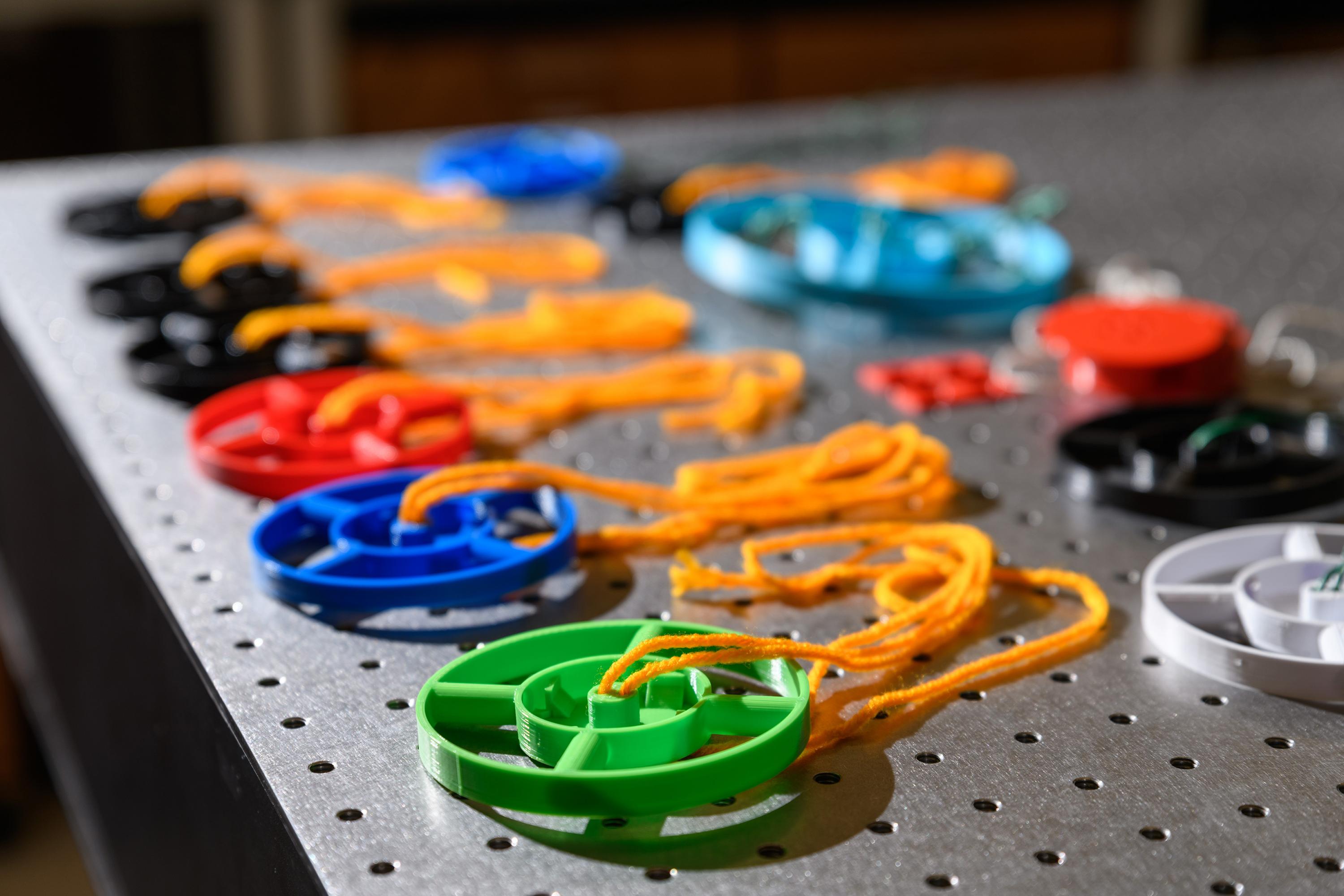 The 3D-Fuge utilizes 3D-printed disks designed to hold small vials of liquid. Simple yarn is used to spin the disks. (Photo: Rob Felt, Georgia Tech).