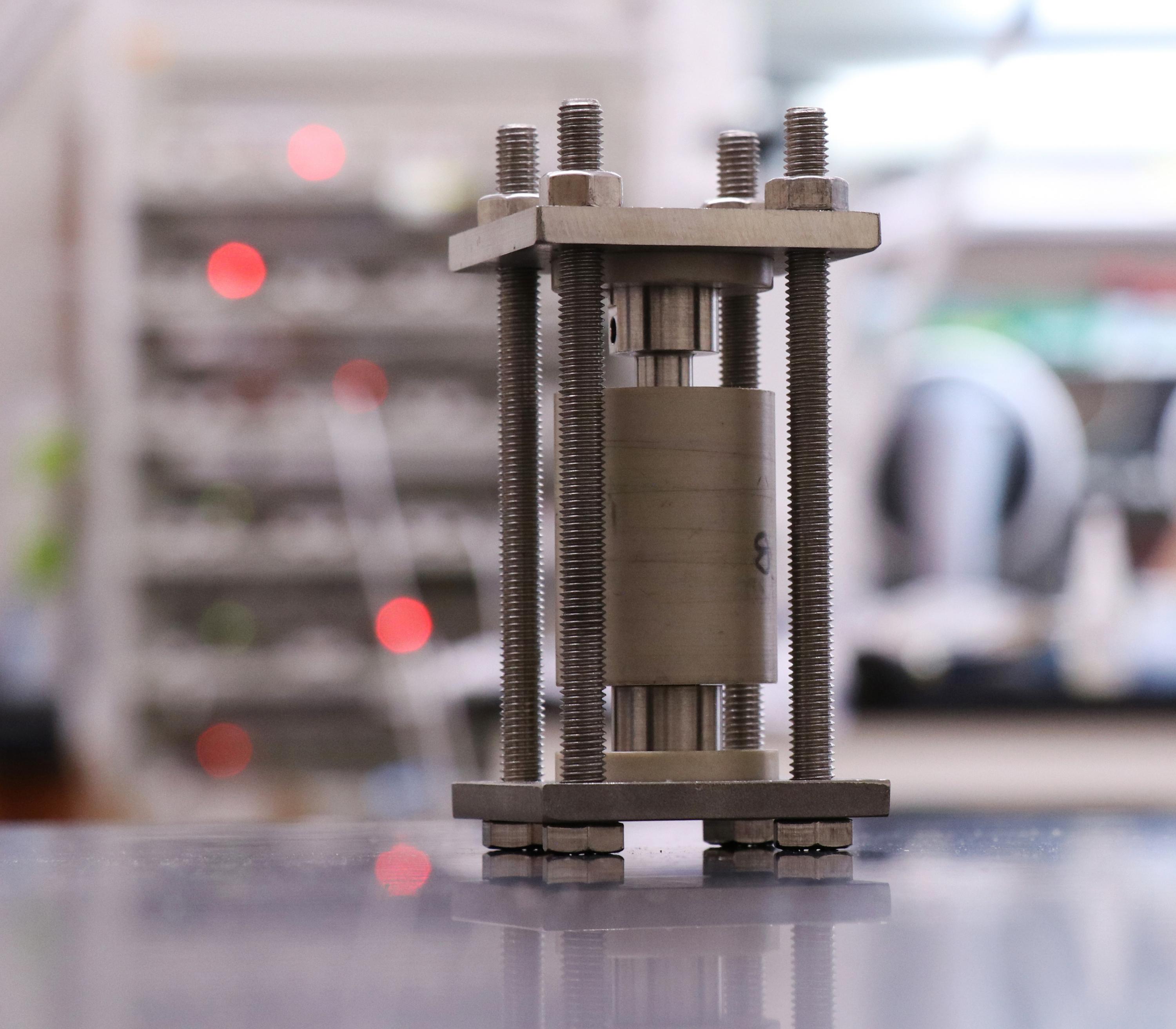 Solid-state batteries are charged and discharged in custom-made hardware designed at Georgia Tech. A smaller, modified version of the cell shown here was used to image these materials during cycling. (Credit: Matthew McDowell)