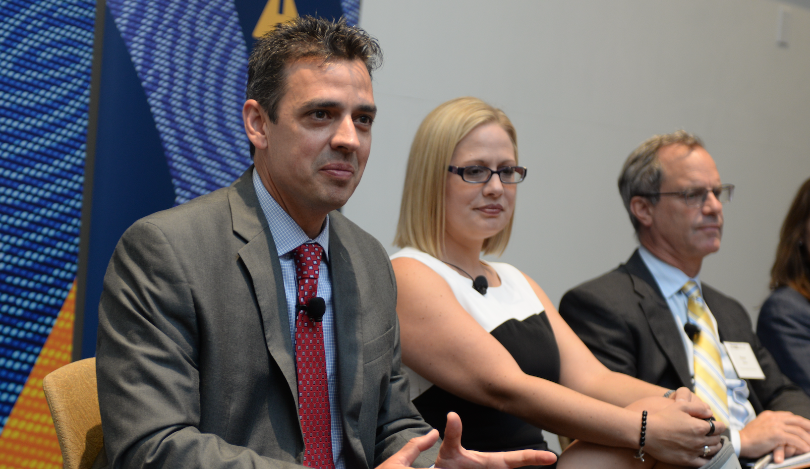 Rep. Tom Graves (R-Ga 14) and Rep. Kyrsten Sinema (D-Ariz. 9) hold a panel discussion at Georgia Tech to talk about cybersecurity policy and technical challenges. Peter Swire, a professor in the Scheller College of Business, was also on the panel. 