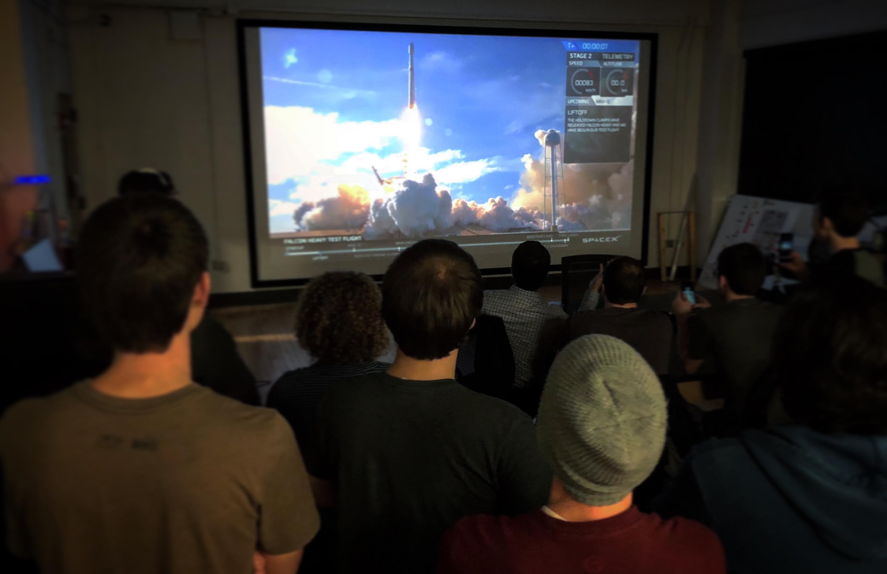 A livestream of the Falcon Heavy launch is projected on a wall-to-wall, floor-to-ceiling screen in the Engineering, Science and Mechanics Building on February 6.