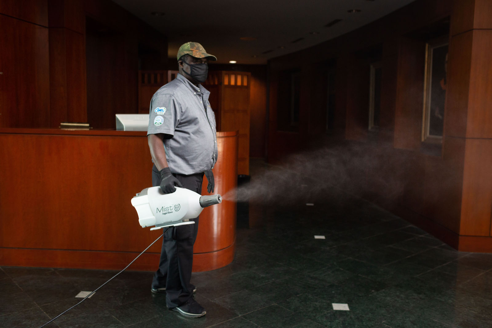 Seth Osekre uses a disinfecting fogger. The disinfectant has a fast evaporation rate, leaving no residue or odor behind. (Photo by Allison Carter)