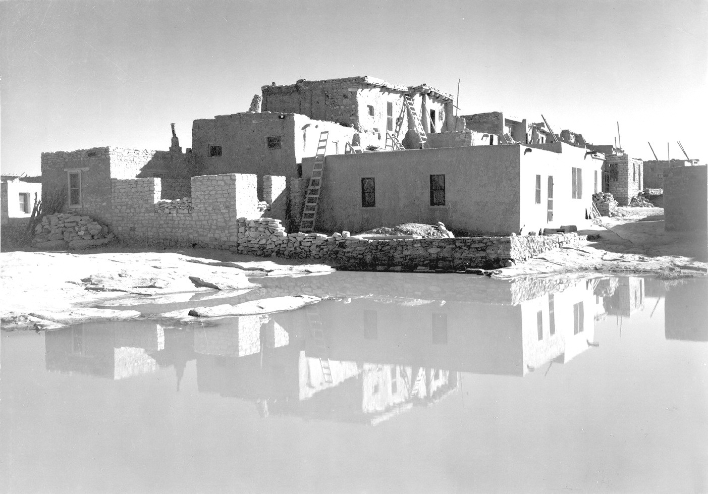 Full Side View of Adobe House with Water in Foreground, Acoma Pueblo [National Historic Landmark, New Mexico]. Credit: National Archives/Ansel Adams/public domain