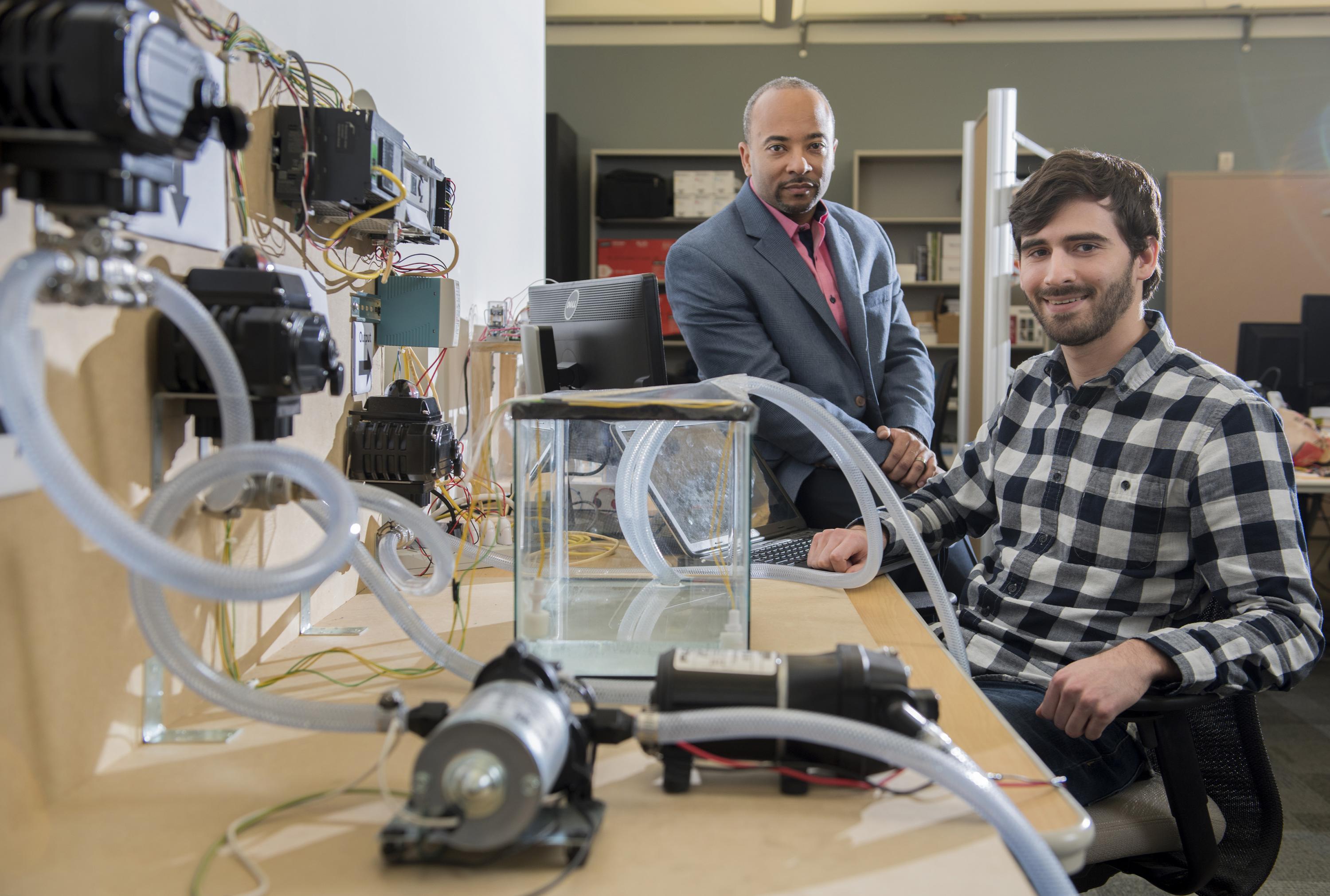 Georgia Tech researchers have developed a new form of ransomware that can take over control of a simulated water treatment plant. The simulated attack was designed to highlight vulnerabilities in the control systems used to operate industrial facilities. Shown are (left) Raheem Beyah, associate chair in the Georgia Tech School of Electrical and Computer Engineering, and David Formby, a Georgia Tech Ph.D. student. (Credit: Christopher Moore, Georgia Tech) 