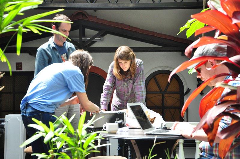 Students work on fixing a sensor used to test air quality in Bolivia.