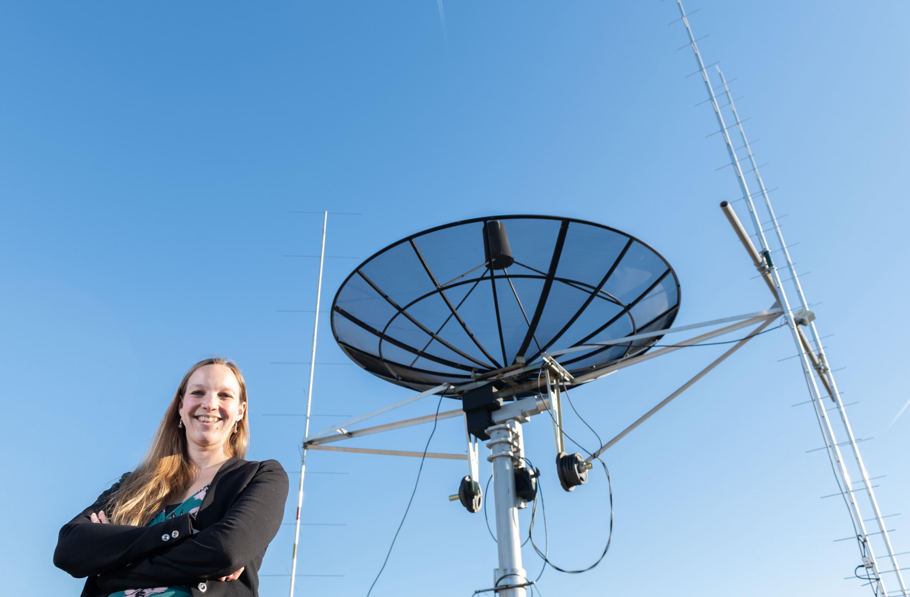 Georgia Tech assistant professor Mariel Borowitz is shown with satellite communications equipment. Dramatic growth in the generation and collection of data will change the way federal agencies make data available. (Photo: Allison Carter, Georgia Tech)