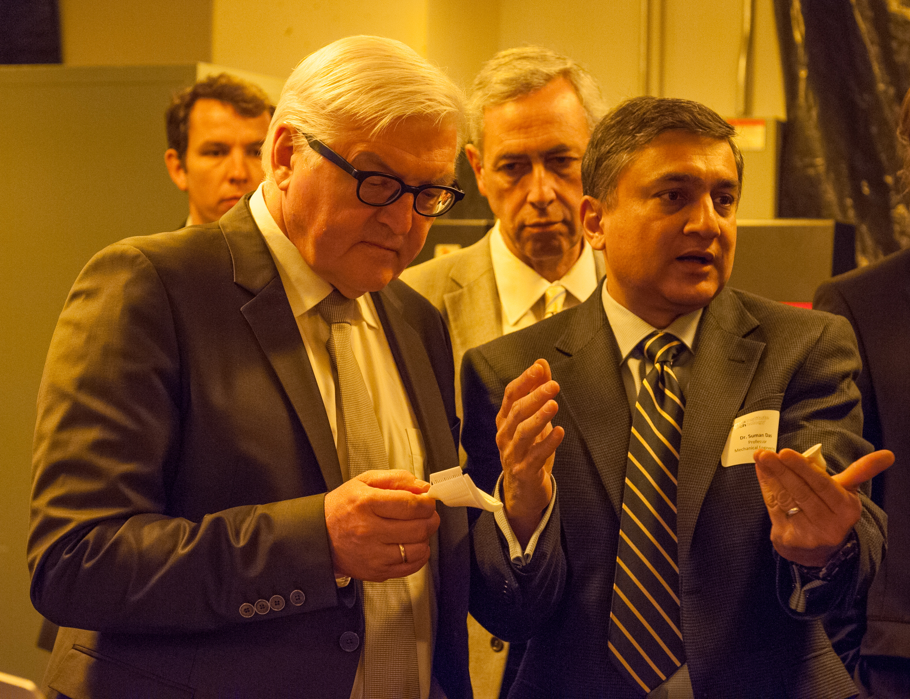 Germany’s Foreign Minister Steinmeier (left) holds a 3-D printed ceramic core made using LAMP, a high-resolution additive manufacturing technology invented by Professor Suman Das (right), director of Georgia Tech's Direct Digital Manufacturing Lab. The technology lowers the time required to turn a CAD design into a test-worthy part from a year to about a week. 