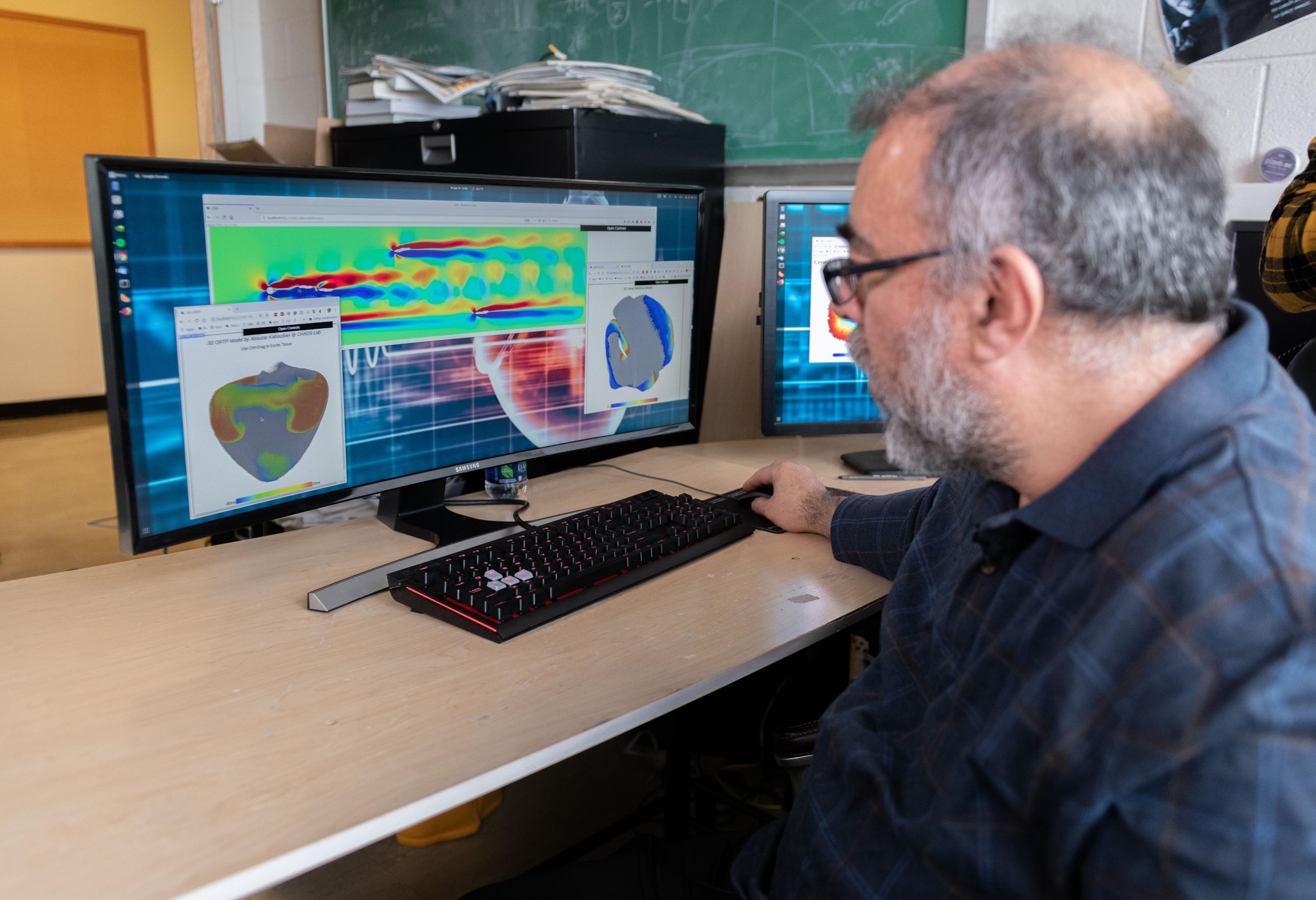 Flavio Fenton, a professor in the School of Physics at the Georgia Institute of Technology, examines cardiac and fluid flow simulations created on a system that uses graphics processing chips designed for gaming applications and software that runs on ordinary web browsers. (Photo: Allison Carter, Georgia Tech) Flavio Fenton, a professor in the School of Physics at the Georgia Institute of Technology, examines cardiac and fluid flow simulations created on a system that uses graphics processing chips designed for gaming applications and software that runs on ordinary web browsers. (Photo: Allison Carter, Georgia Tech)