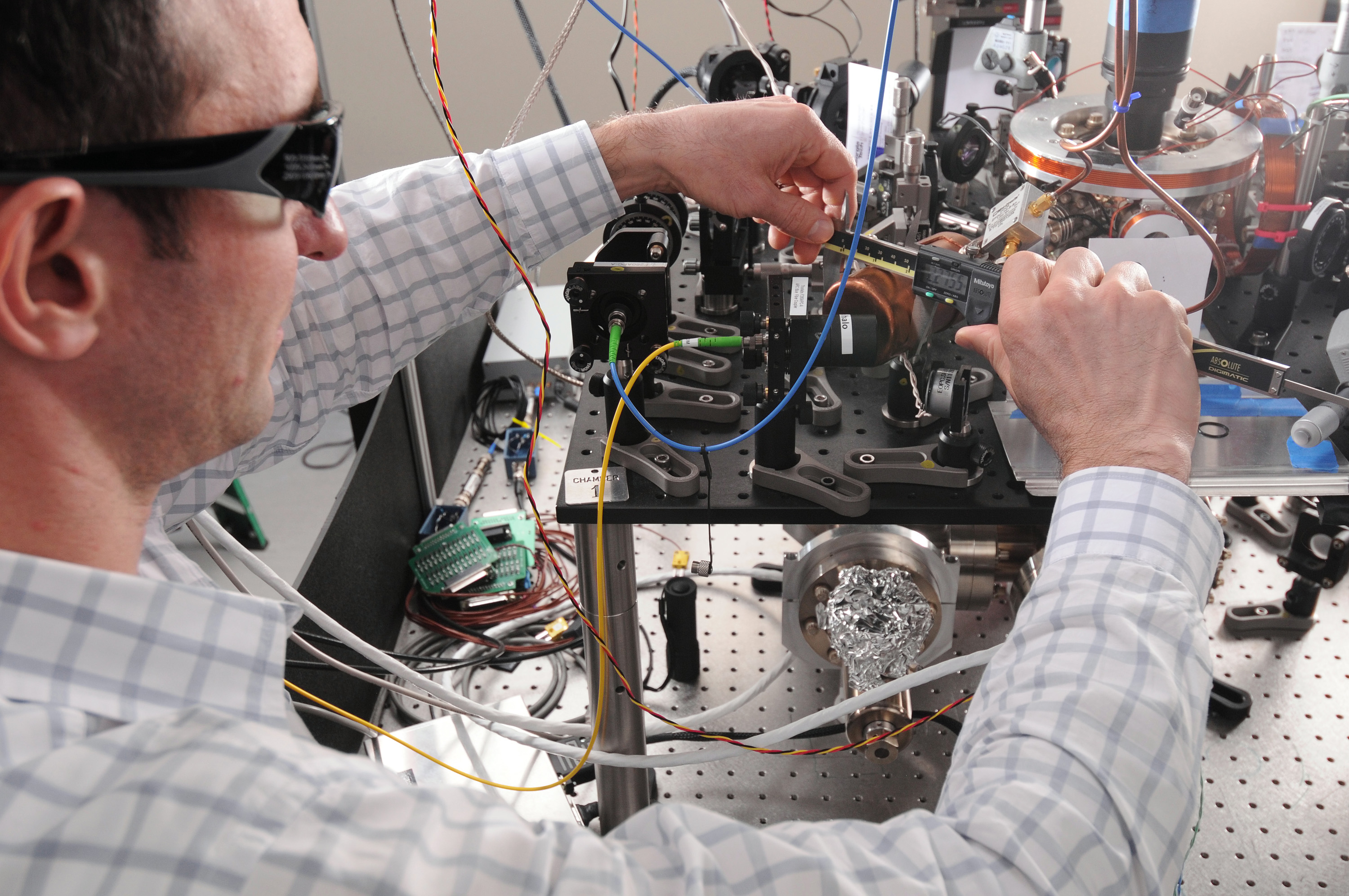 Researcher Kenton Brown adjusts optical components in an experimental setup within GTRI’s Quantum Information Systems Branch. (Credit: Gary Meek)