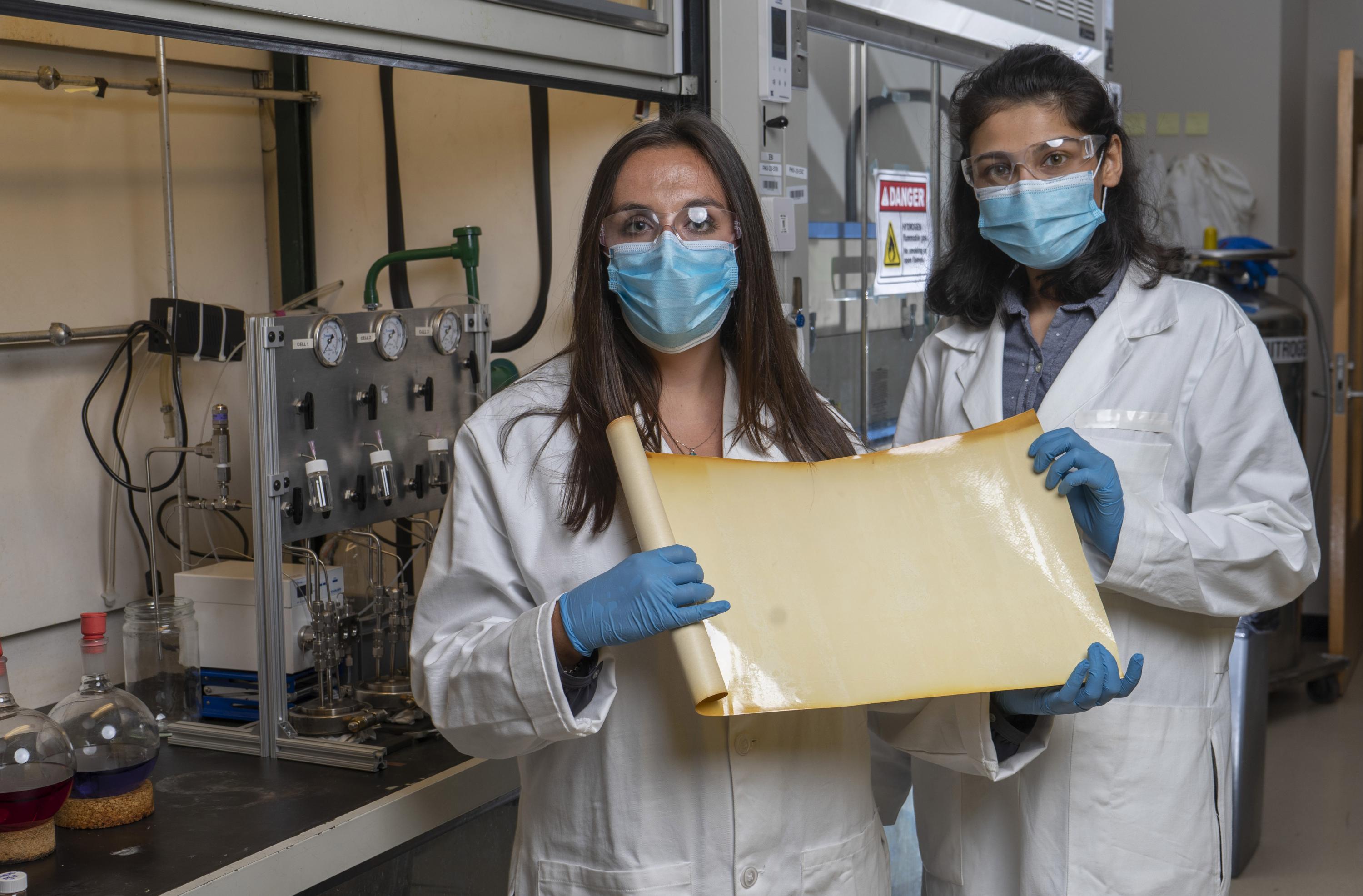 Georgia Tech graduate research assistants Kirstie Thompson and Ronita Mathias with a sample of a new membrane material that could reduce carbon emissions and energy intensity associated with refining crude oil. (Credit: Christopher Moore, Georgia Tech) Georgia Tech graduate research assistants Kirstie Thompson and Ronita Mathias with a sample of a new membrane material that could reduce carbon emissions and energy intensity associated with refining crude oil. (Credit: Christopher Moore, Georgia Tech)