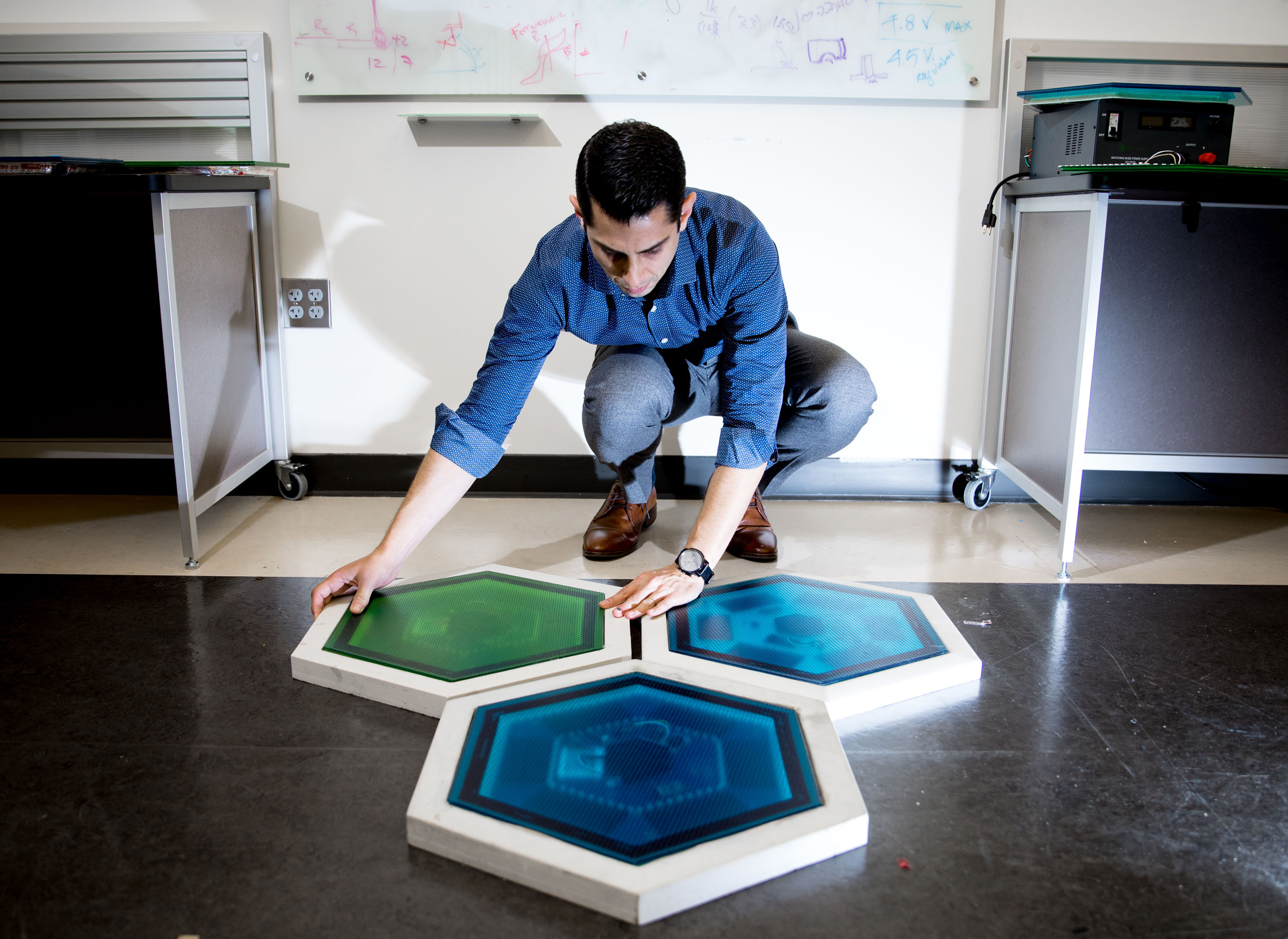 Ilan Stern, a GTRI senior research scientist, shows piezoelectric tiles that will be used to create a lighted outdoor footpath at the NASA Kennedy Space Center’s Visitor Complex at Cape Canaveral, Florida. He’s holding the electronic components used in the tiles. (Credit: Branden Camp, Georgia Tech) Ilan Stern, a GTRI senior research scientist, shows piezoelectric tiles that will be used to create a lighted outdoor footpath at the NASA Kennedy Space Center’s Visitor Complex at Cape Canaveral, Florida. He’s holding the electronic components used in the tiles. (Credit: Branden Camp, Georgia Tech)