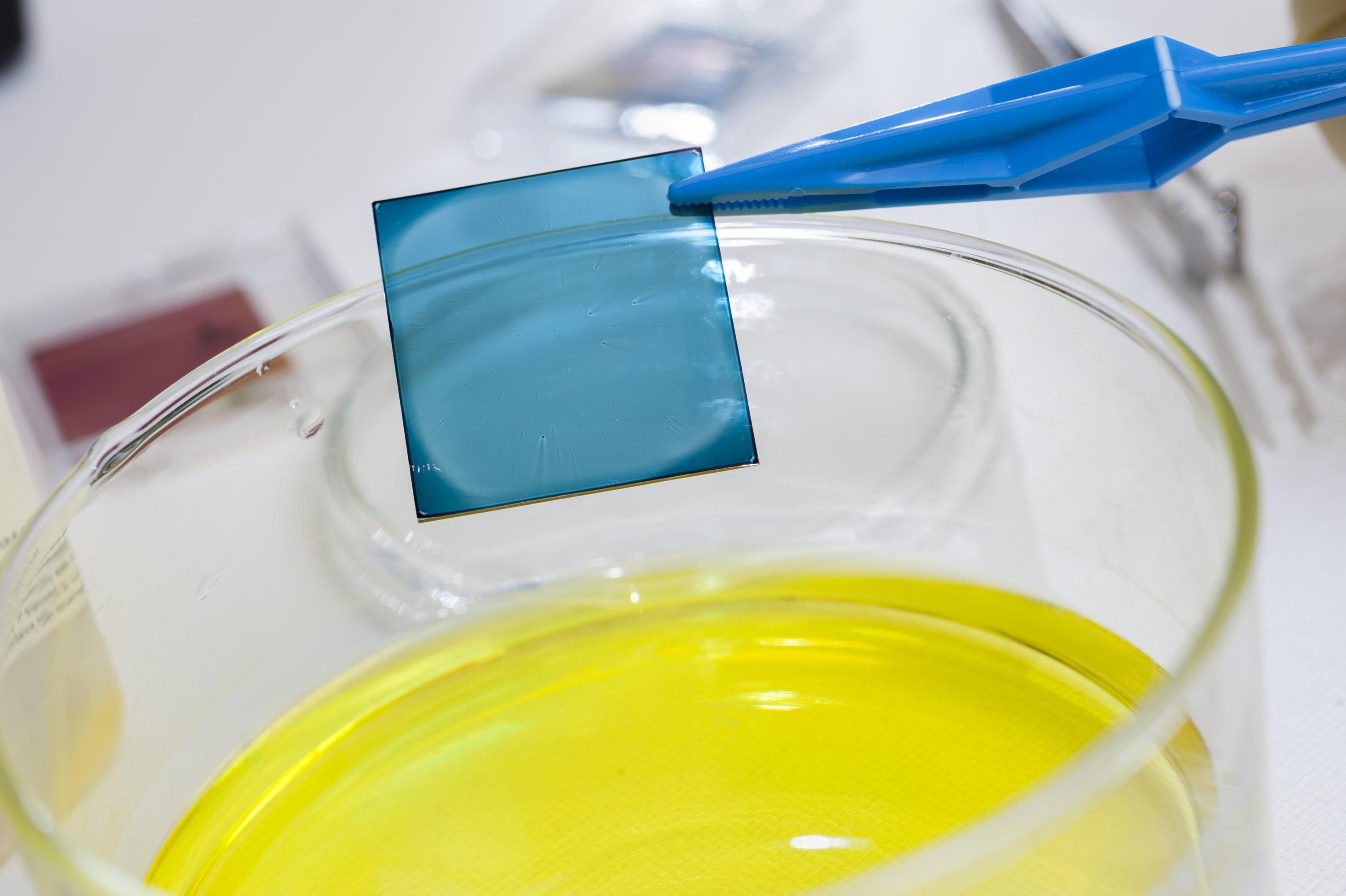 Close-up of a polymer film on a glass substrate before immersion in a polyoxometalte solution to electrically dope the film over a limited depth. (Credit: Christopher Moore, Georgia Tech)