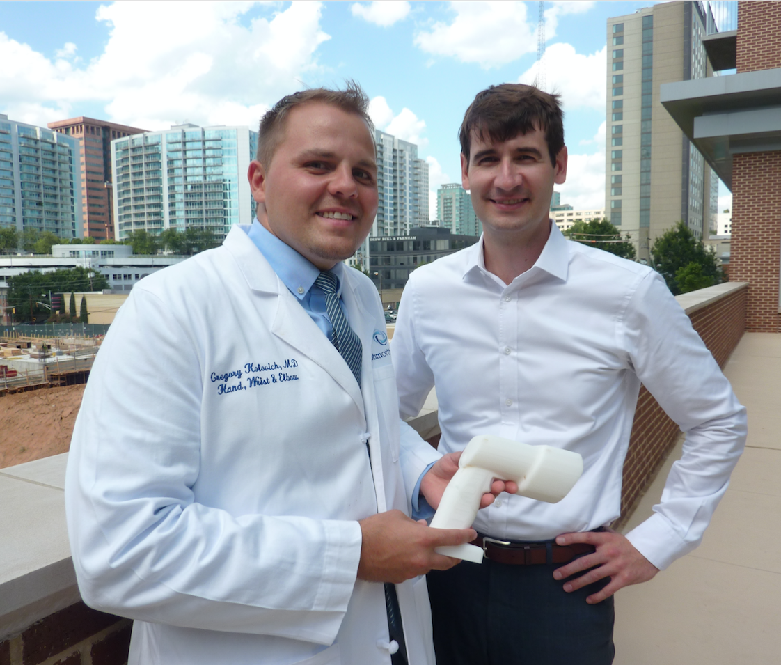 Dr. Greg Kolovich, an orthopedic hand and micro-surgeon (left), stands with business partner Evan Ruff. Kolovich is the founder of Micro C, a Savannah-based company that developed an all-in-one, hand-held X-ray and digital camera for surgeons and physicians treating disorders of the extremities. Ruff is CEO and a third partner, Kirby Sisk, is chief operating officer. Kolovich, Ruff, and Sisk are all graduates of Georgia Tech. (Photo credit: Péralte C. Paul) Dr. Greg Kolovich, an orthopedic hand and micro-surgeon (left), stands with business partner Evan Ruff. Kolovich is the founder of Micro C, a Savannah-based company that developed an all-in-one, hand-held X-ray and digital camera for surgeons and physicians treating disorders of the extremities. Ruff is CEO and a third partner, Kirby Sisk, is chief operating officer. Kolovich, Ruff, and Sisk are all graduates of Georgia Tech. (Photo credit: Péralte C. Paul)