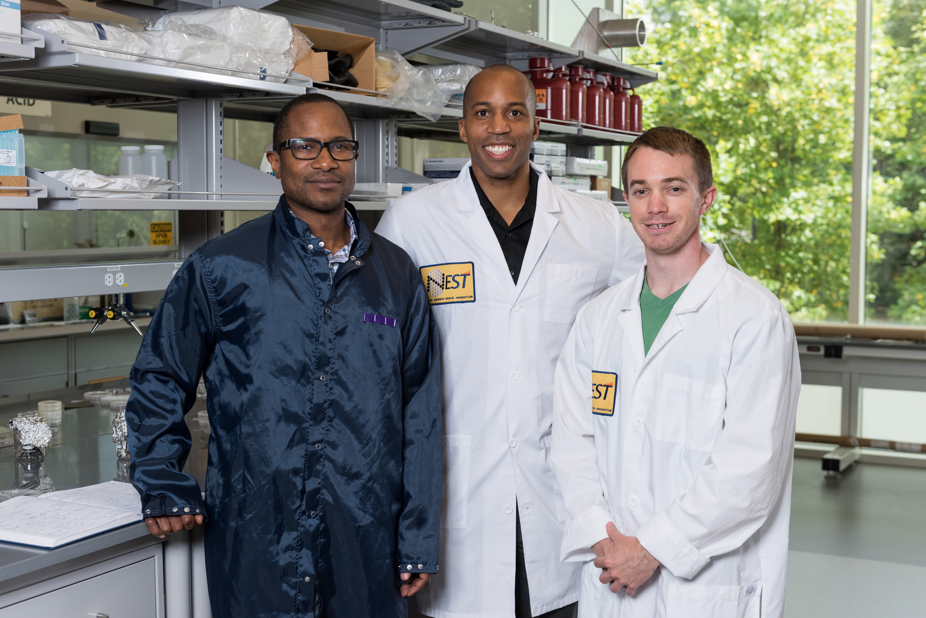 Researchers have shown that silicon dioxide nanoparticles coated with a high dielectric constant polymer might inexpensively provide improved cooling for electronic devices. Shown (l-r) are Professor James Hammonds from Howard University, Associate Professor Baratunde Cola from Georgia Tech, and Georgia Tech Graduate Student Eric Tervo. (Credit: Rob Felt, Georgia Tech)